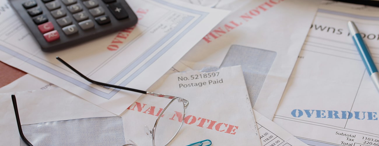 Unpaid Bills on Table with Calculator