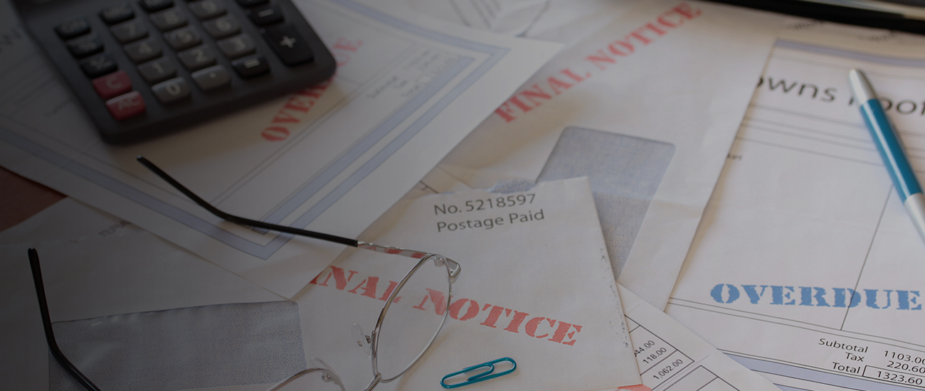 Unpaid Bills on Table with Calculator